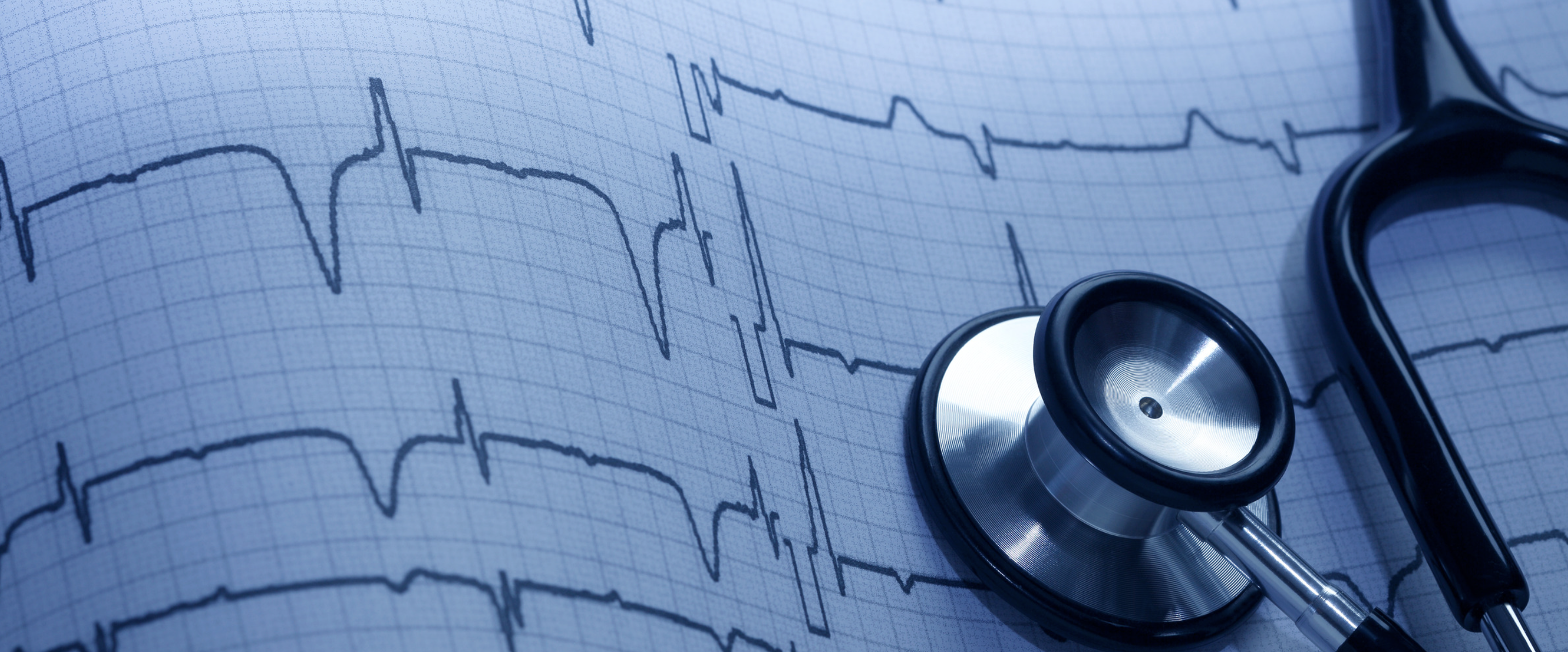 Healthcare and Life Sciences: a stethoscope resting on an EKG heart-rhythm printout in blue tones